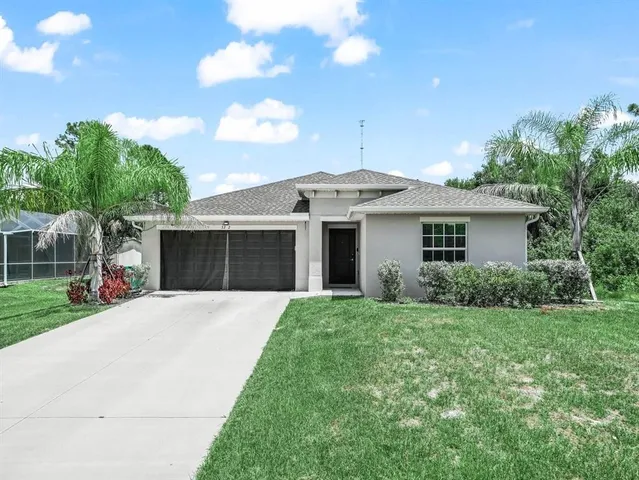 a front view of house with yard and green space