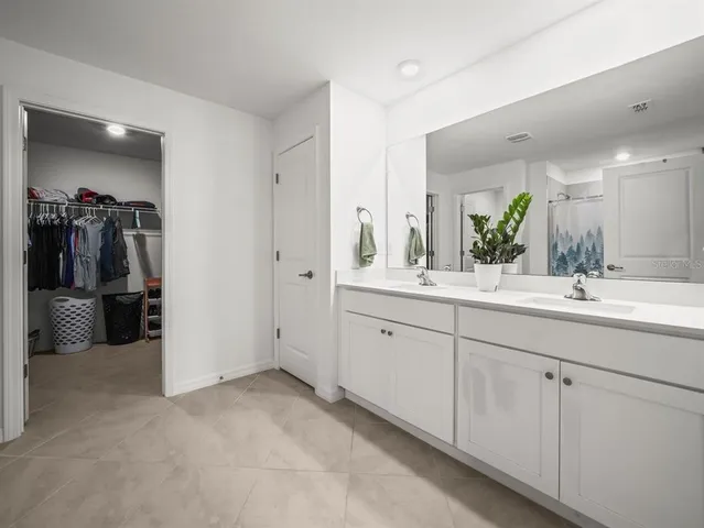 a bathroom with a double vanity sink and a mirror