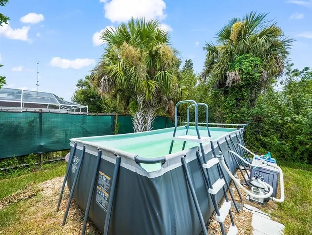 a view of a swimming pool with a patio