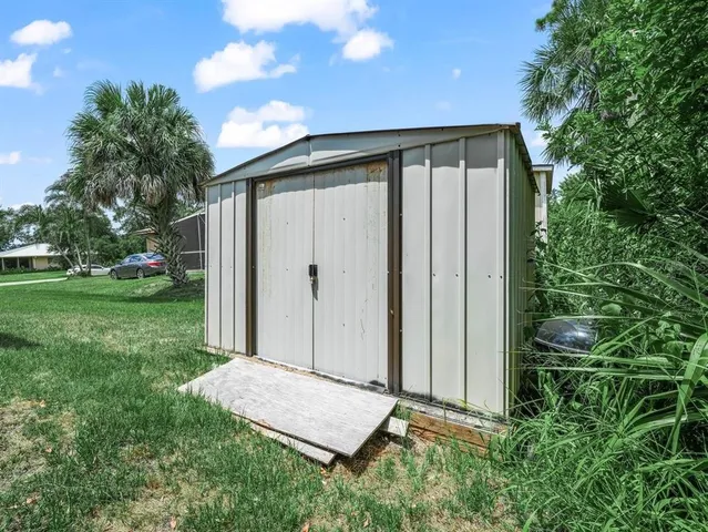 a backyard of a house with plants and outdoor seating