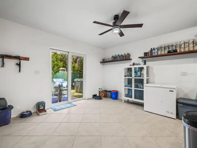 a view of a livingroom with lounge chair and windows