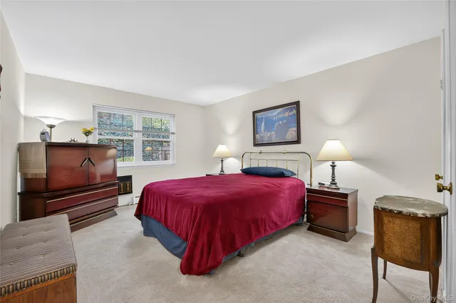 a bedroom with a bed and a tv on dresser