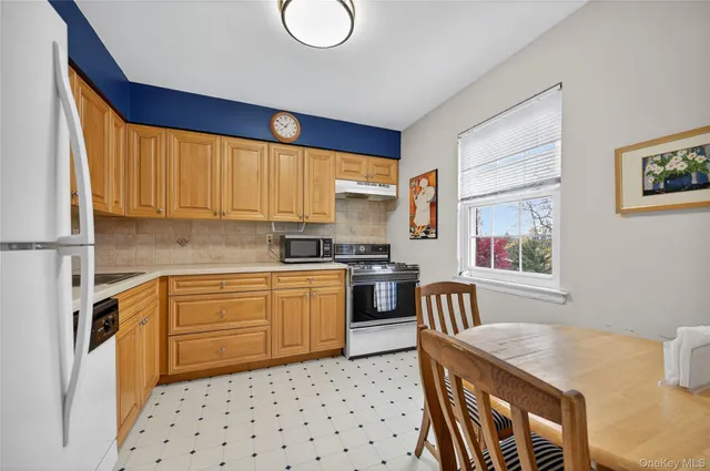 a kitchen with a refrigerator and a sink