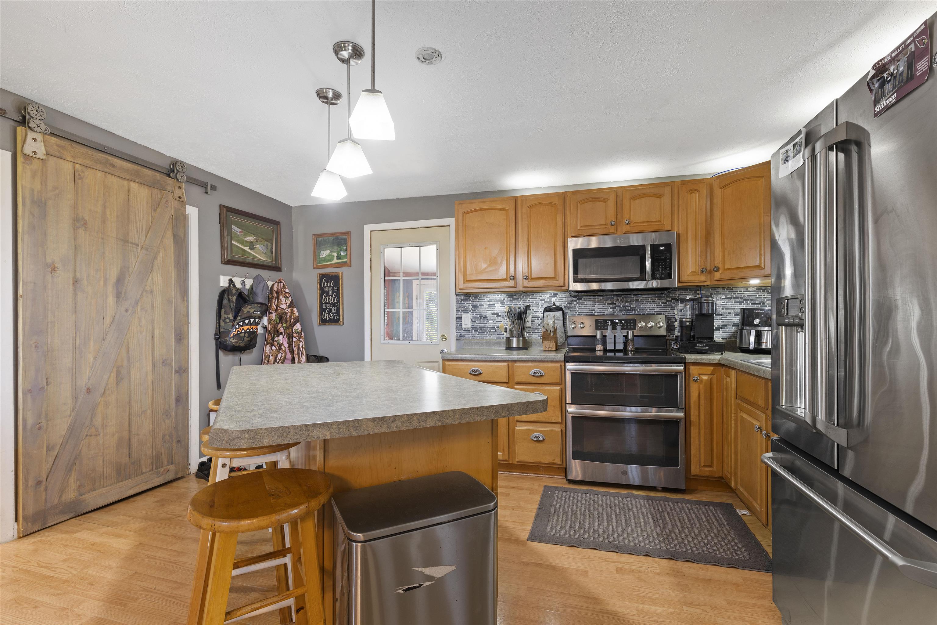 10784 East Utility Road Stillman Valley, IL 61084 - Photo 8 of 23 a kitchen with stainless steel appliances granite countertop a refrigerator stove and sink