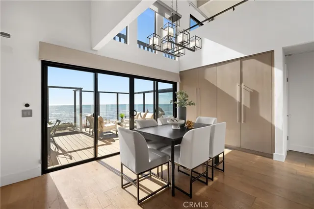 a view of a dining room with furniture wooden floor and chandelier