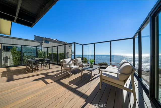 a living room with patio furniture and a wooden floor