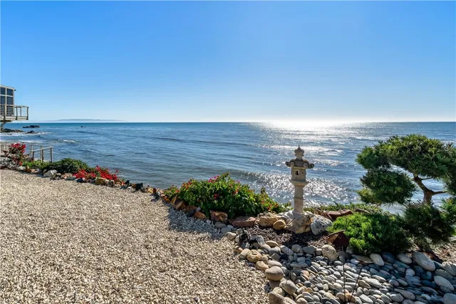 a view of a balcony with two chairs and a potted plant