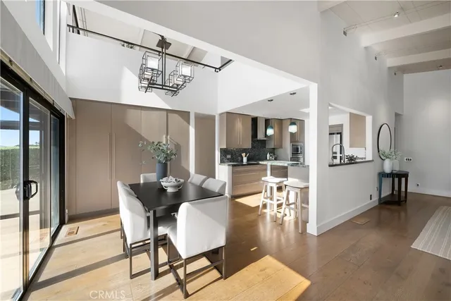 a kitchen with stainless steel appliances granite countertop a refrigerator a sink and white cabinets