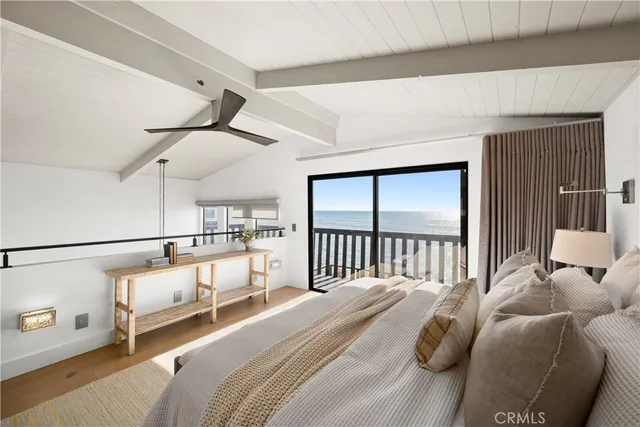 a bedroom with a bed and a view of living room