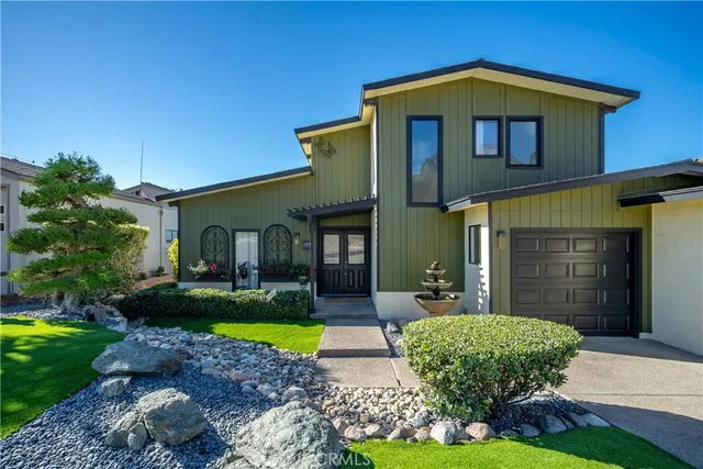 a front view of a house with garden