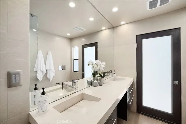 a front view of a house with a yard and potted plants