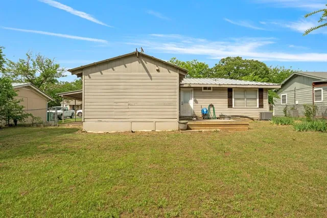 a view of a house with pool and a yard