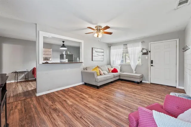 a living room with furniture and wooden floor