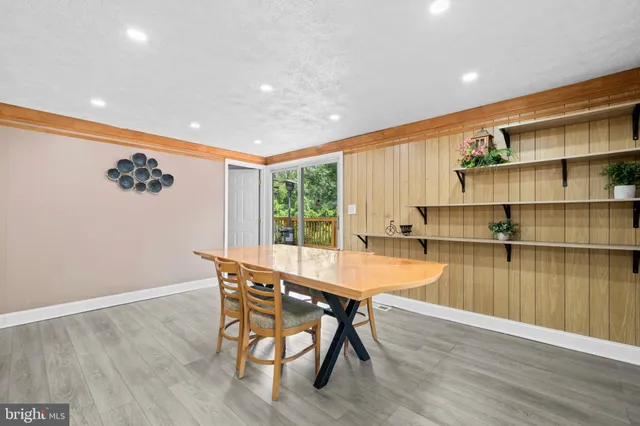 a dining room with furniture and wooden floor