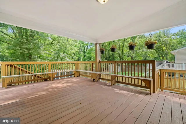 a view of a deck with a floor to ceiling window and wooden floor