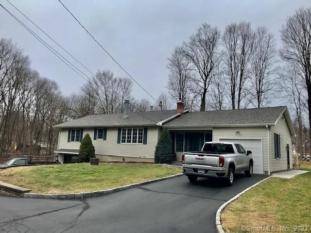 46 Weed Road Bethel, CT 06801 - Photo 1 of 1 a front view of a house with a garden and parking