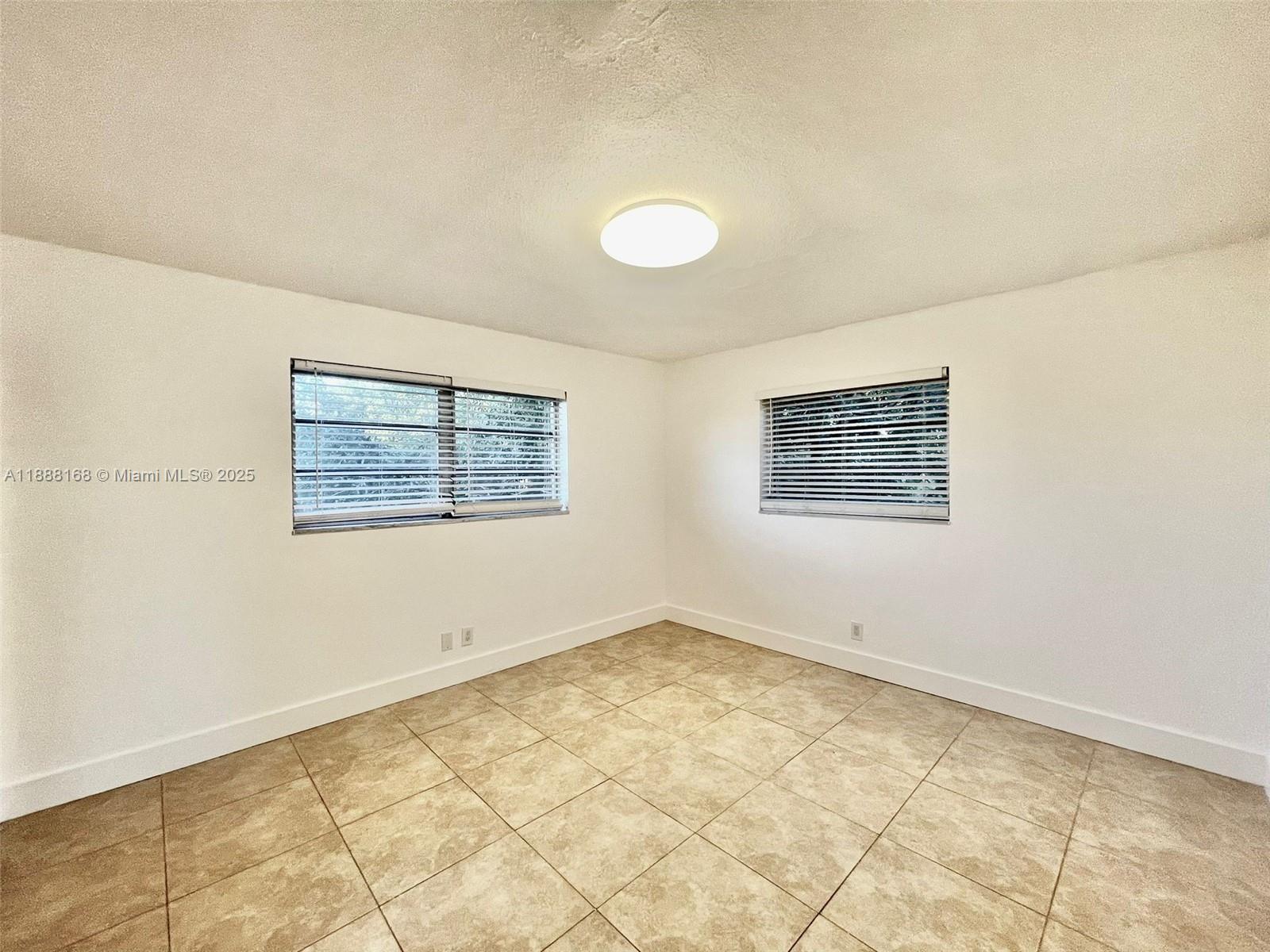 2255 Southeast 5th Street, Unit 10 Pompano Beach, FL 33062 - Photo 3 of 10 an empty room with a empty space and window