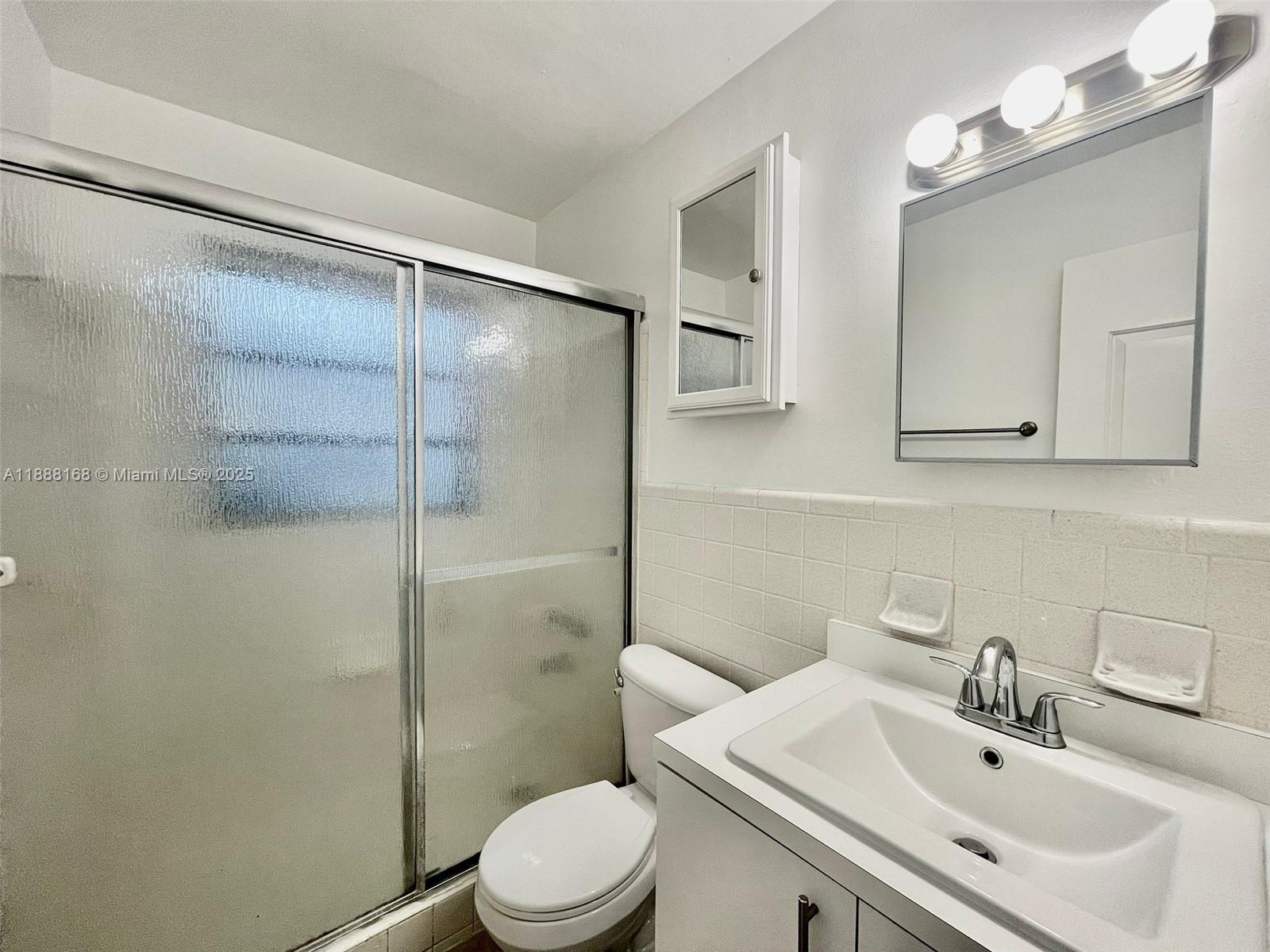2255 Southeast 5th Street, Unit 10 Pompano Beach, FL 33062 - Photo 8 of 10 a bathroom with a sink toilet and shower