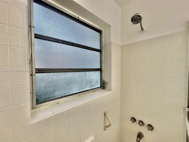 a bathroom with a shower and a sink