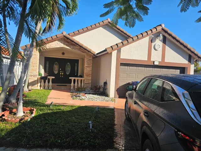 a view of a house with backyard porch and furniture