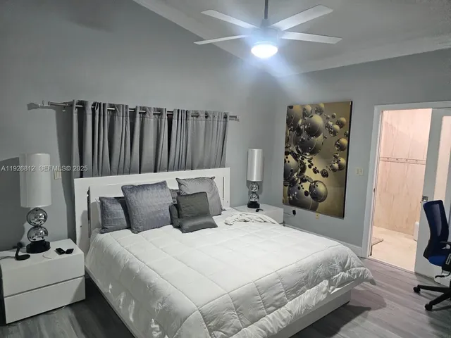 a bedroom with a bed and a chair in it