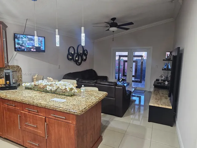a kitchen with a sink a counter and chairs