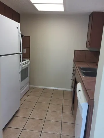 a kitchen with a refrigerator and a stove