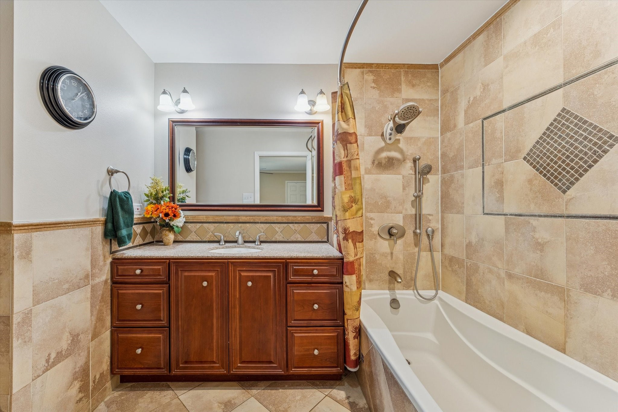 10902 Mullins Drive Houston, TX 77096 - Photo 11 of 20 a bathroom with a granite countertop sink a mirror a vanity and a bathtub