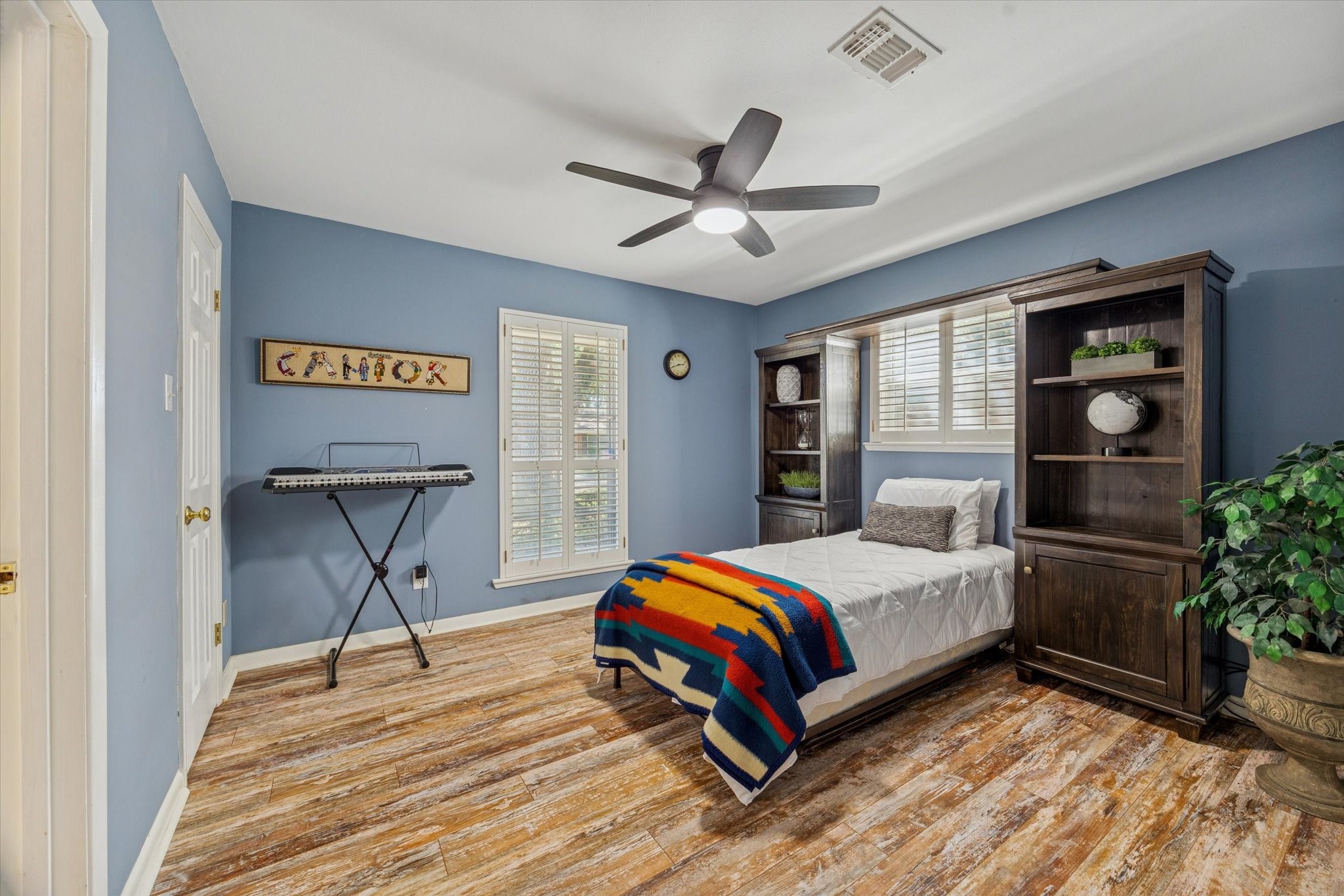 10902 Mullins Drive Houston, TX 77096 - Photo 15 of 20 a bedroom with a bed and a potted plant