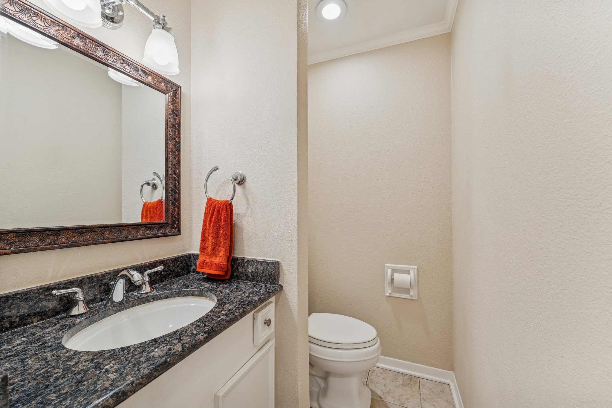 10902 Mullins Drive Houston, TX 77096 - Photo 16 of 20 a bathroom with a granite countertop sink a toilet and a mirror