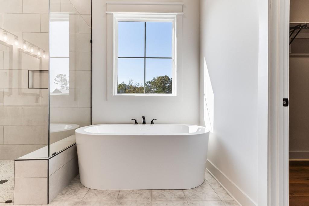 62 Ridgewood Creek Path Dallas, GA 30157 - Photo 12 of 31 a white bath tub sitting in a bathroom