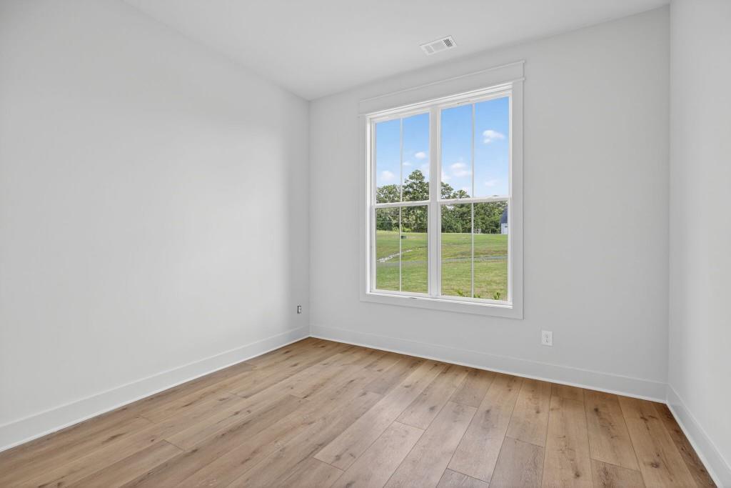 62 Ridgewood Creek Path Dallas, GA 30157 - Photo 15 of 31 a view of an empty room with wooden floor and a window