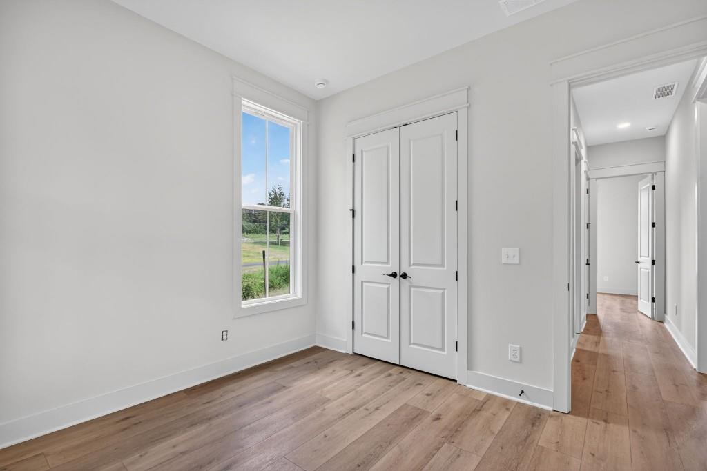 62 Ridgewood Creek Path Dallas, GA 30157 - Photo 20 of 31 a view of an empty room with wooden floor and a window
