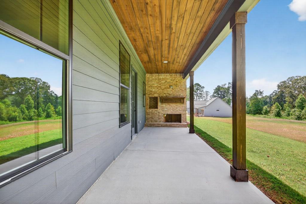 62 Ridgewood Creek Path Dallas, GA 30157 - Photo 22 of 31 a view of a porch with furniture and garden
