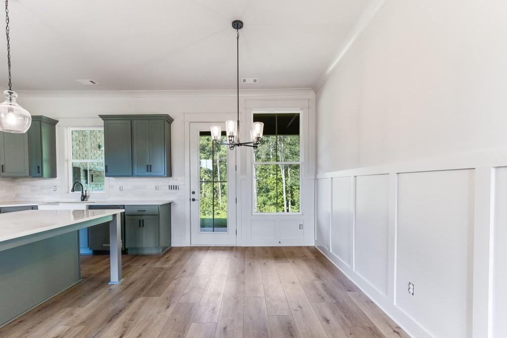 62 Ridgewood Creek Path Dallas, GA 30157 - Photo 7 of 31 a kitchen with stainless steel appliances granite countertop a stove a sink and a wooden floor