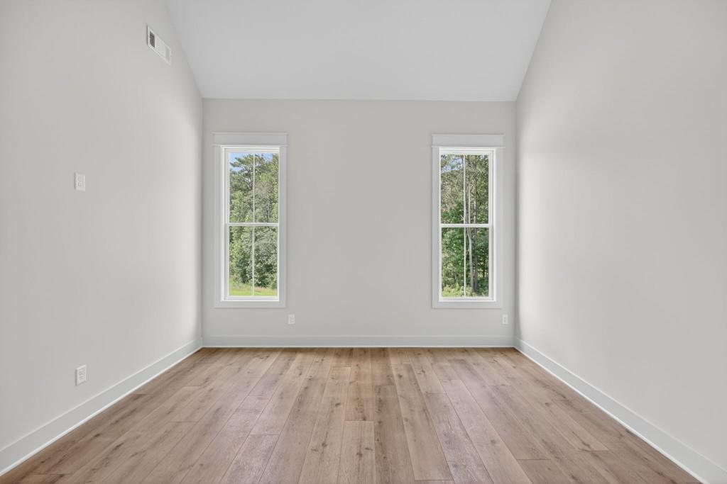 62 Ridgewood Creek Path Dallas, GA 30157 - Photo 8 of 31 an empty room with wooden floor and windows