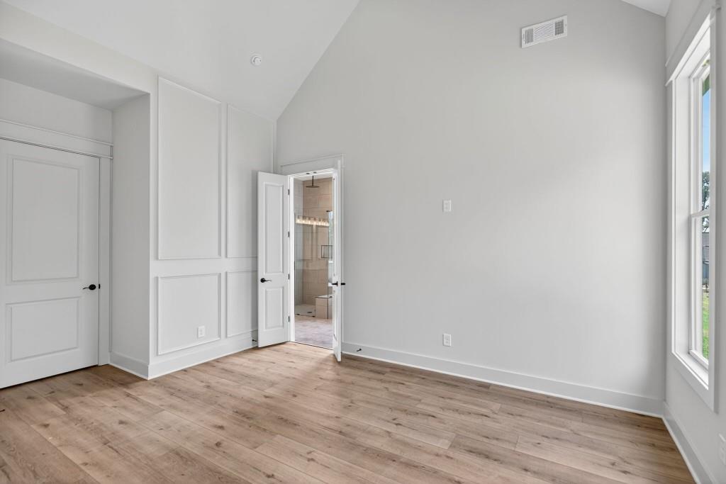 62 Ridgewood Creek Path Dallas, GA 30157 - Photo 9 of 31 a view of an empty room with wooden floor and window