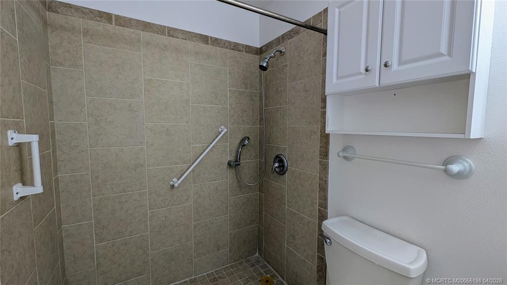 Undisclosed Address Stuart, FL 34996 - Photo 11 of 28 a bathroom with a shower a toilet and sink