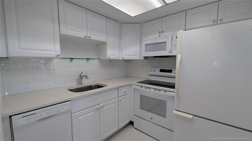 Undisclosed Address Stuart, FL 34996 - Photo 26 of 28 a kitchen with cabinets appliances and a sink