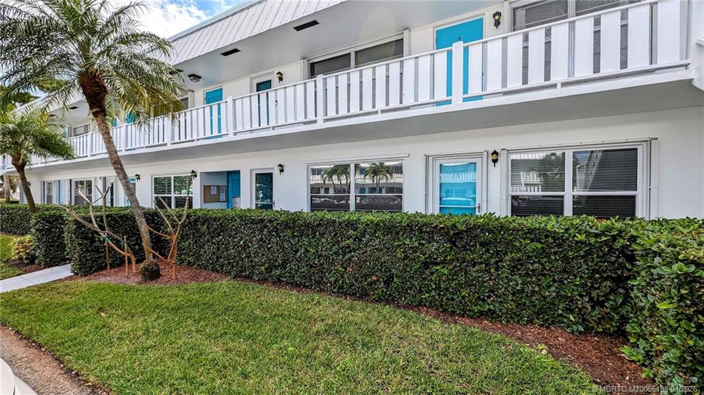 Undisclosed Address Stuart, FL 34996 - Photo 4 of 28 a front view of a house with a yard