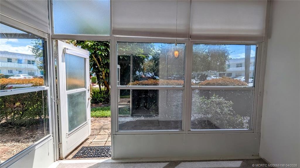 Undisclosed Address Stuart, FL 34996 - Photo 8 of 28 a view of a living room with a floor to ceiling window and outdoor view