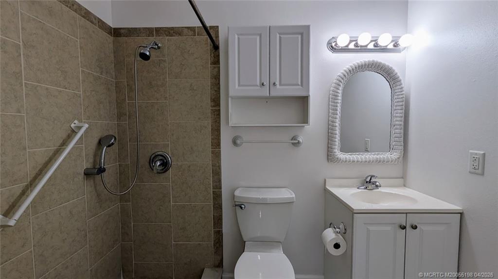 Undisclosed Address Stuart, FL 34996 - Photo 10 of 28 a bathroom with a sink a toilet and shower
