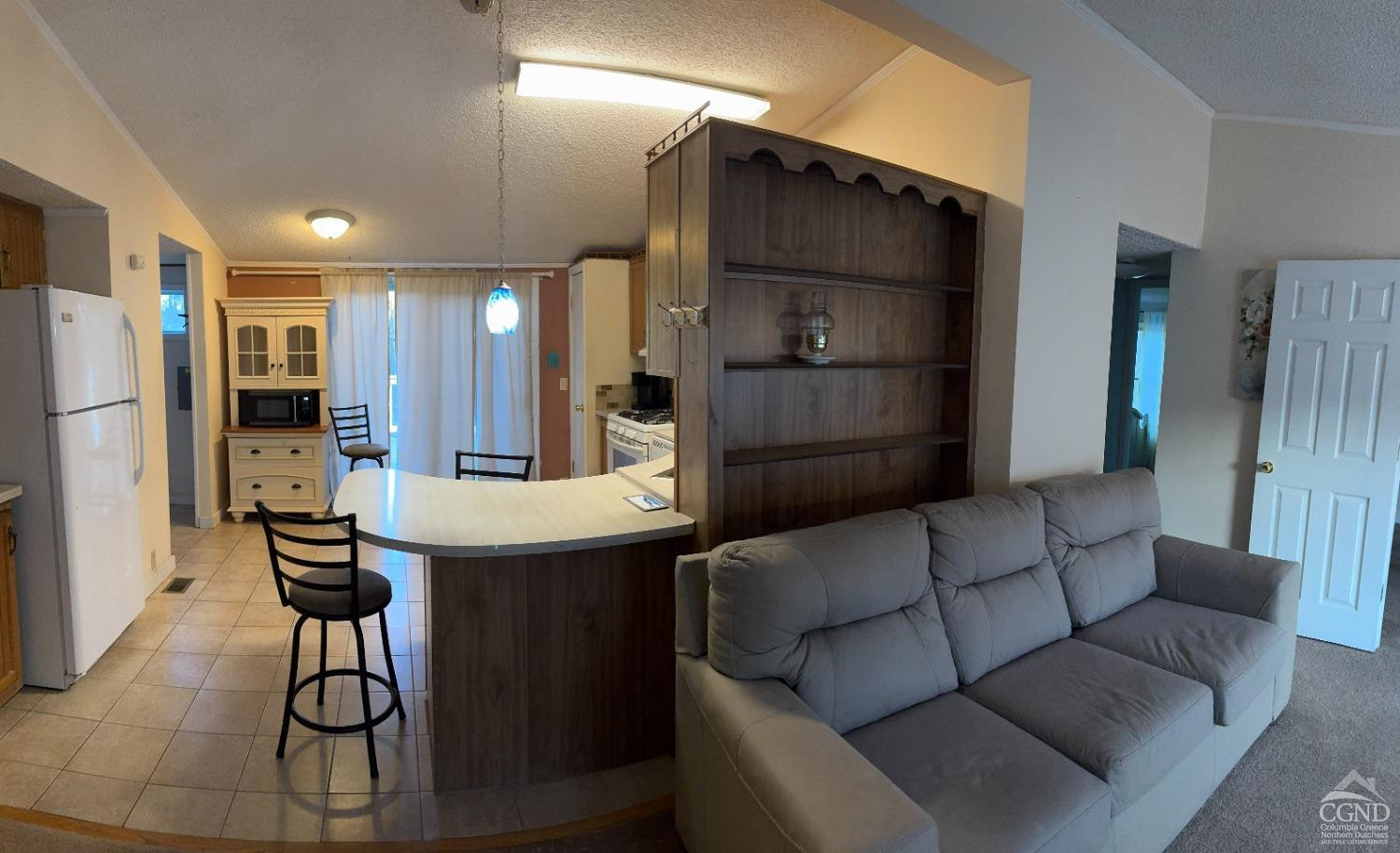 1406 Rte 31 Germantown, NY 12526 - Photo 9 of 25 a living room with furniture a refrigerator and kitchen view