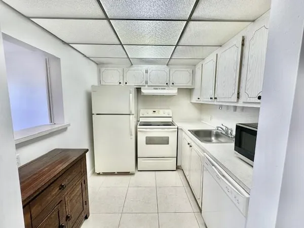 a kitchen with stainless steel appliances a refrigerator sink and cabinets