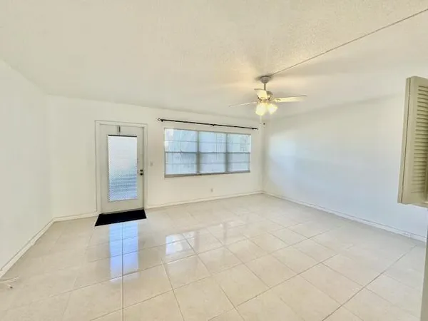 an empty room with a empty space and windows