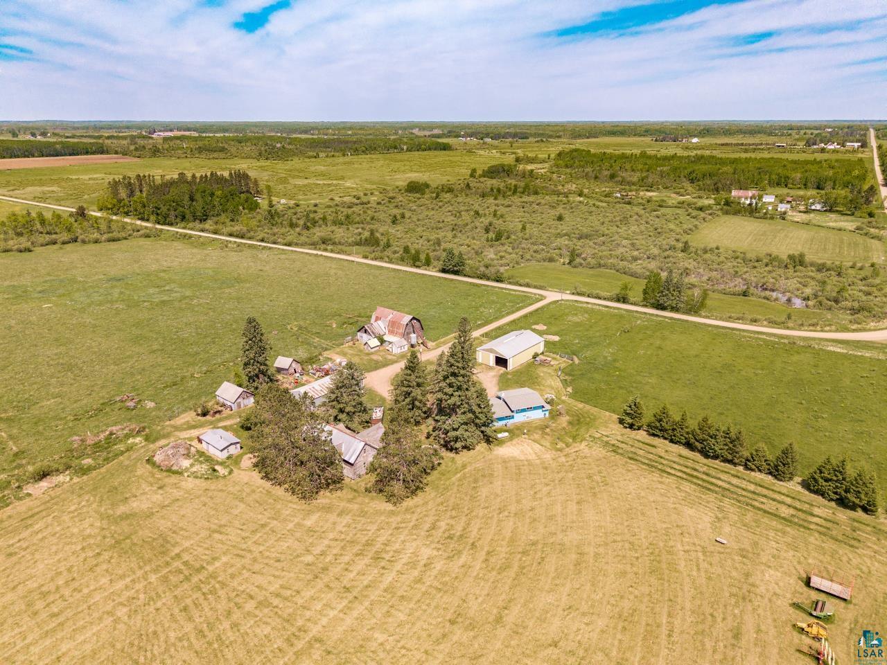6606 Metso Road Kettle River, MN 55757 - Photo 48 of 84 Expansive acreage featuring multiple outbuildings, mature trees, and agricultural fields