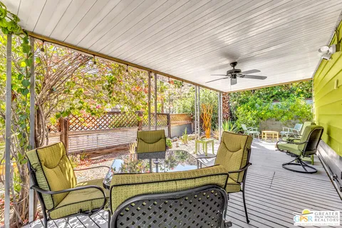 a view of a patio with table and chairs and potted plants