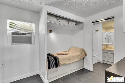 a kitchen with stainless steel appliances a table and chairs in it