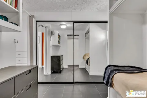 a bedroom with a bed and table chair