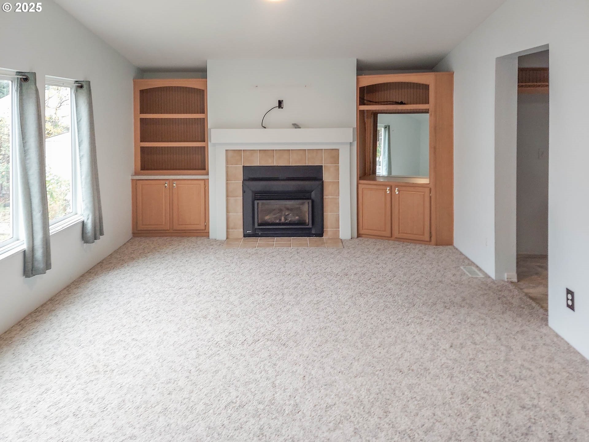 210 Northwest Timothy Avenue Winston, OR 97496 - Photo 12 of 38 a view of an empty room with a fireplace and a window
